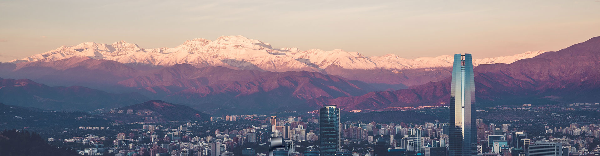 The city of Santiago below the snowcapped peaks of the Andes Mountain Range in Chile.