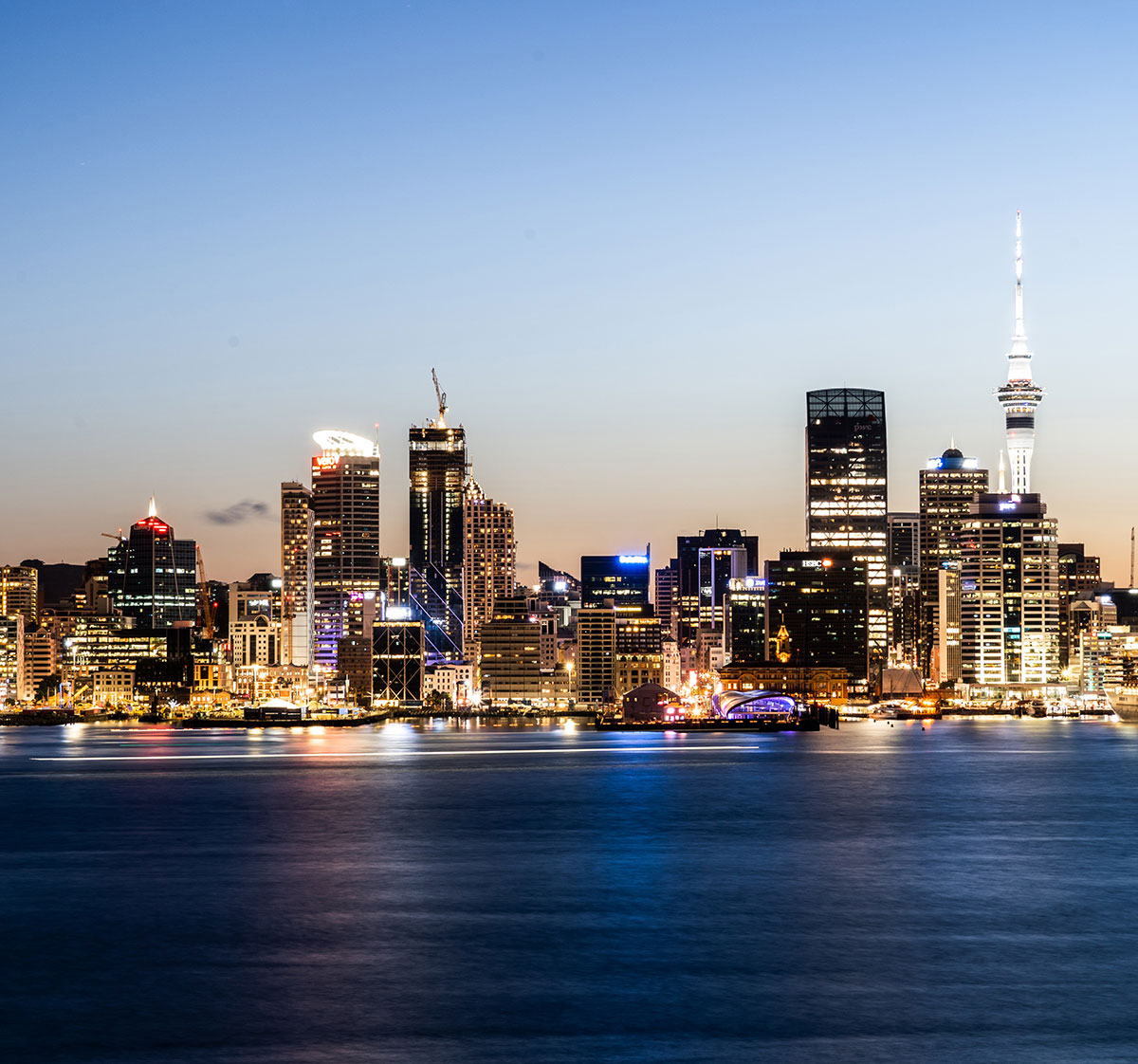 The Auckland city skyline seen from across the water at night.