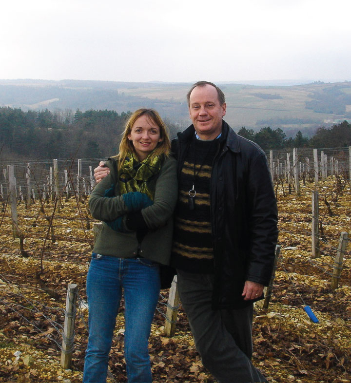 Chris and Liz Watson standing in their vineyard in Chablis, Burgundy, France.