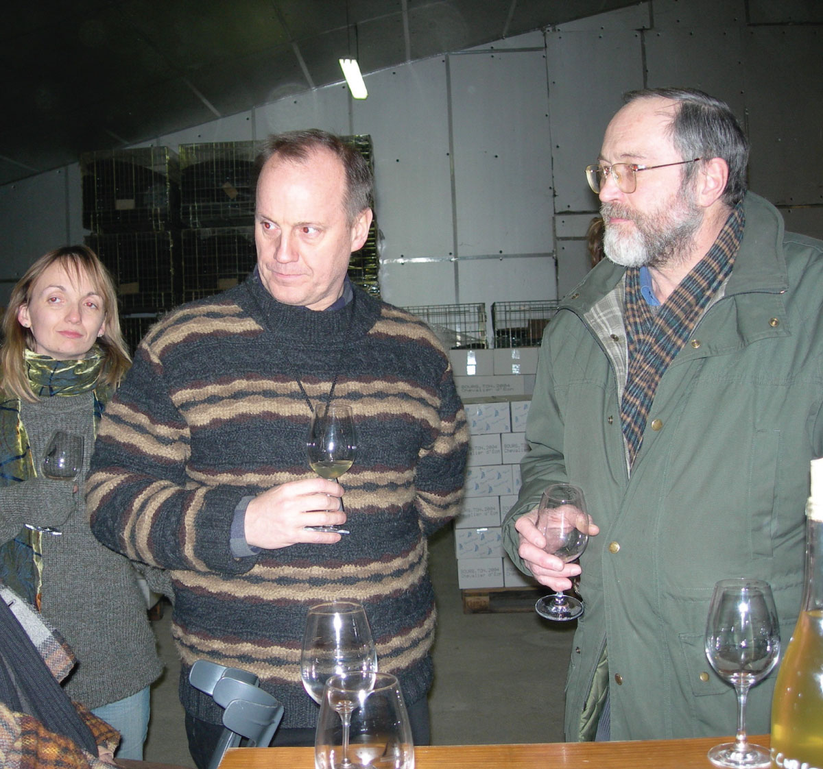 Chris and Liz Watson taste wine in a cellar with their close friend, Jean-Paul.