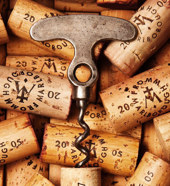 An old corkscrew from the vast collection at the winery lies on top of FROMM wine corks.