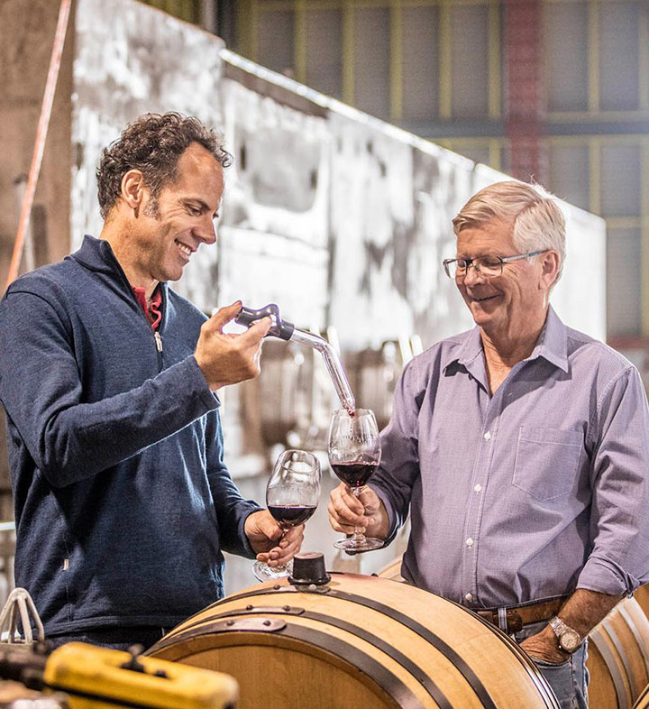 Tellurian winemaker, Tobias Ansted and owner Ian Hopkins tasting organic wine from a barrel.